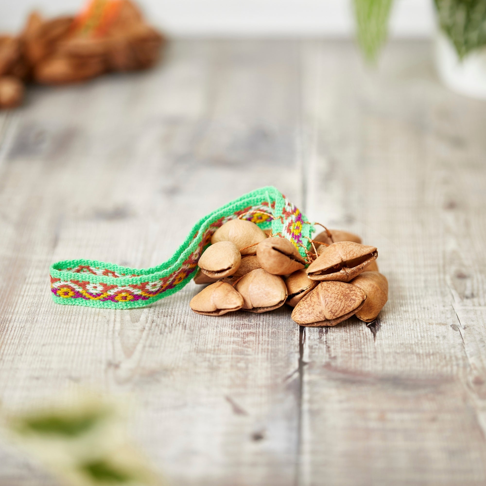 Lima nut shaker with green ribbon