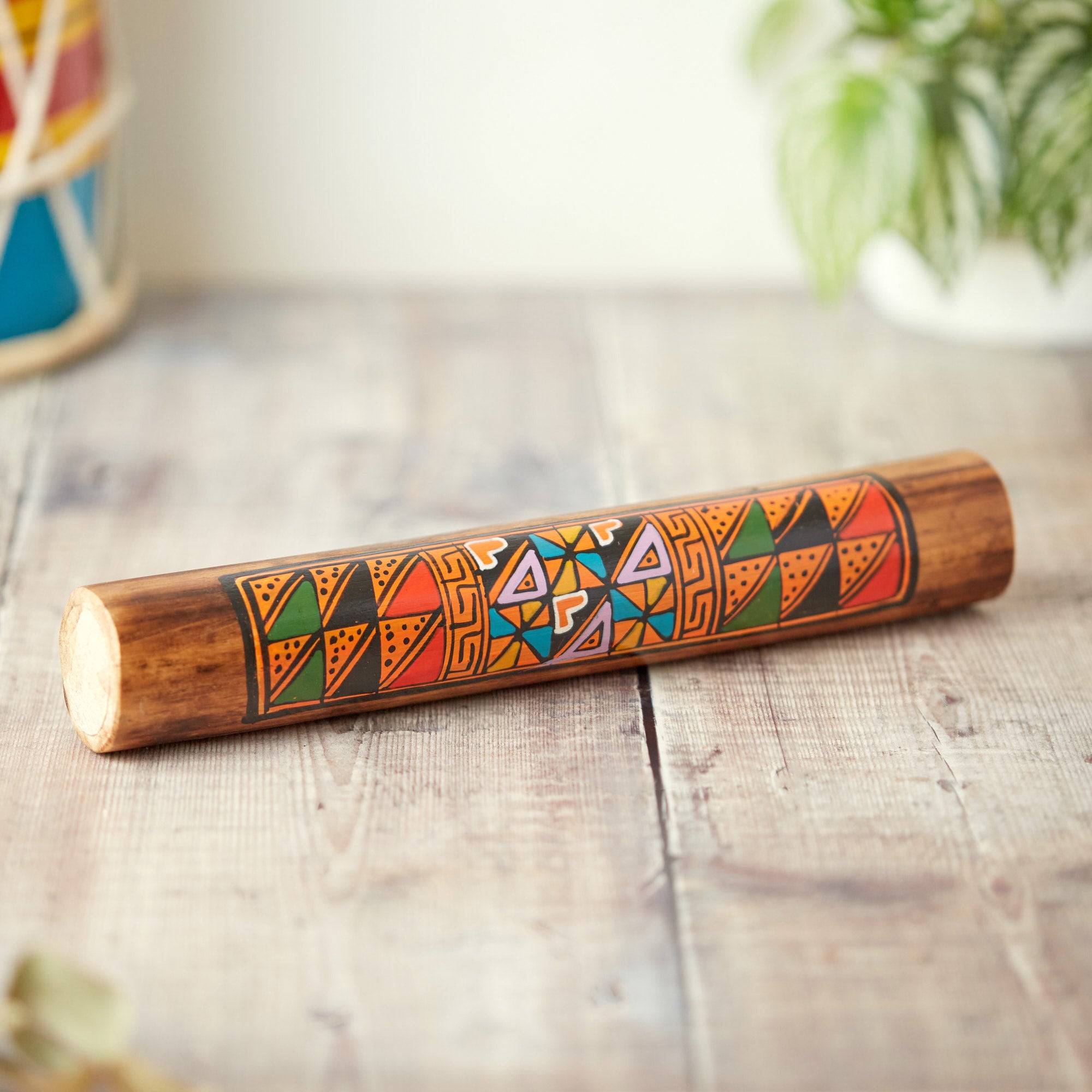 Hand painted bamboo rainstick with geometric designs