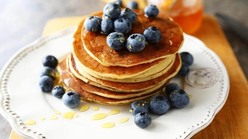 American pancakes with blueberries and syrup