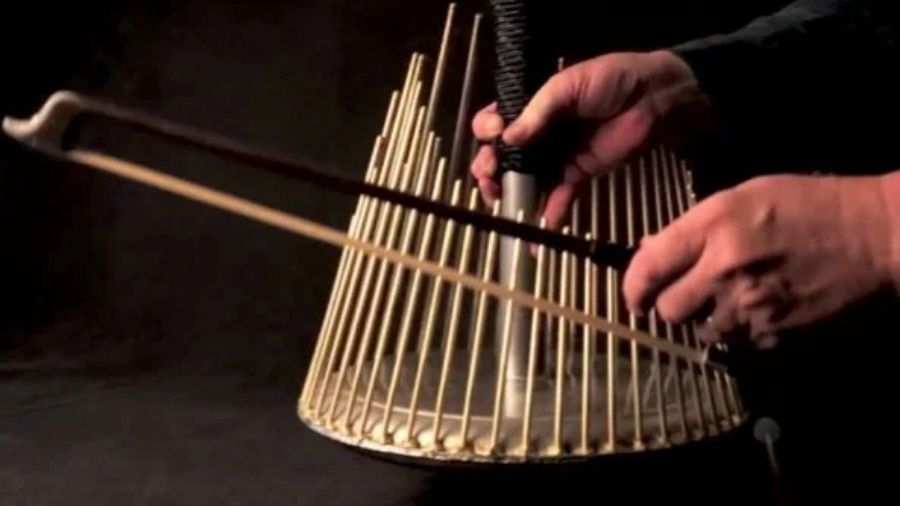 A close-up view of a waterphone, showing its metal rods and resonator bowl.