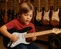 Kid playing black strat electric guitar in music shop with guitar display in background