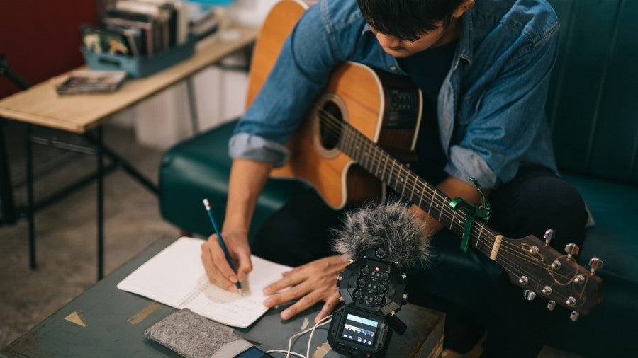 Songwriter or composer composing sheet music writing on paper