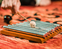 8 Note Indonesian Aura Meditation Chime being played on traditional batik fabric