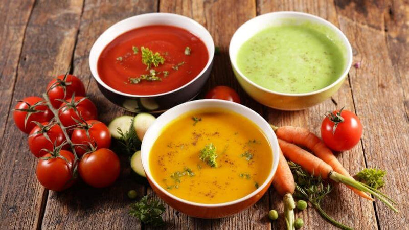 trio of tomato soup, carrot soup and pea soup