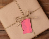 Packaged product wrapped in kraft paper with jute bow