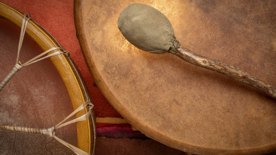 Shamanic drums of different size and a shamanic drum beater