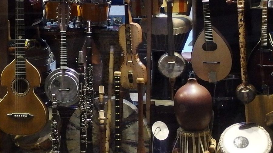 Musical instruments arranged in a cinematic, moody setting with warm, atmospheric lighting.