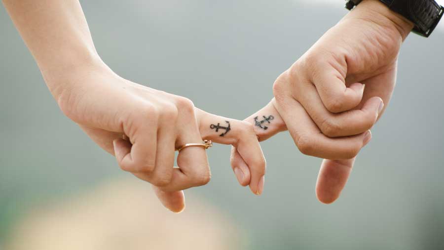 couple holding fingers making promises
