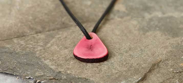 pink tagua nut seed on a cotton wax cord 