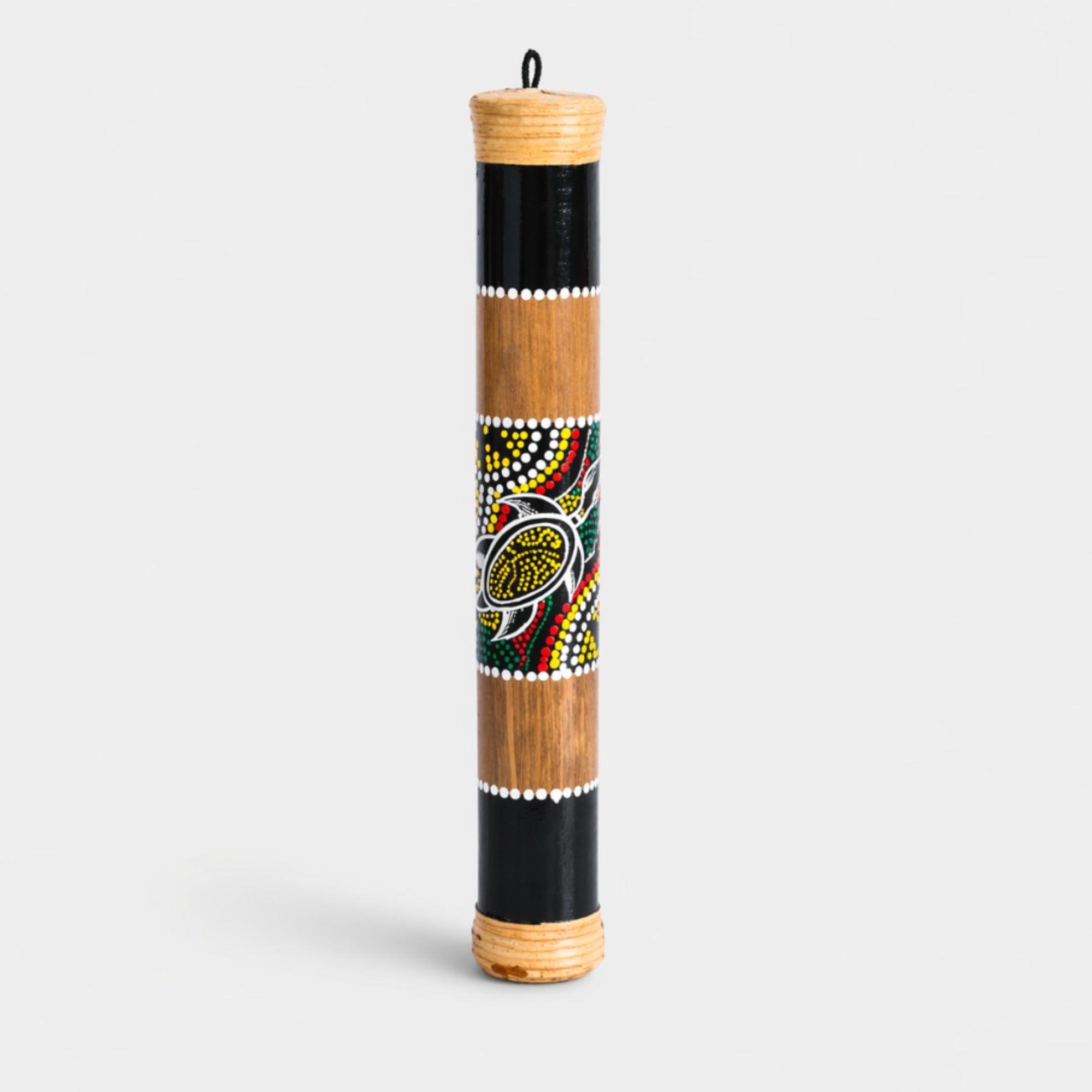 Natural 40cm Bamboo Rainstick Instrument with hand painted dotted aboriginal design on studio Background
