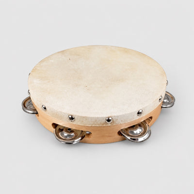 Tambourine with wooden head and metal jingles on a white background