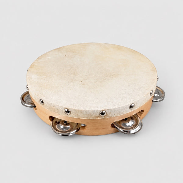 Tambourine with wooden head and metal jingles on a white background