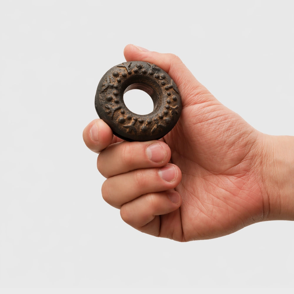 Meo finger bell, metal percussion instrument held in hand for scale