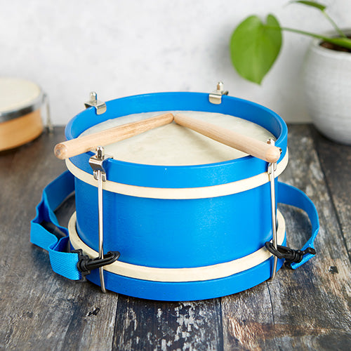 blue and white marching drum with beaters