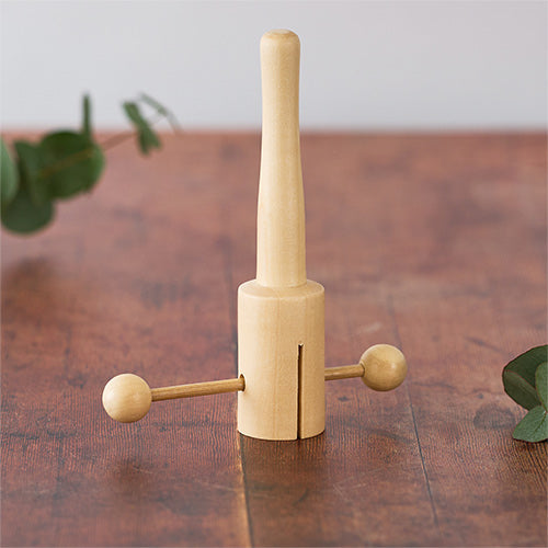 Matsu T-clacker musical instrument on wooden table