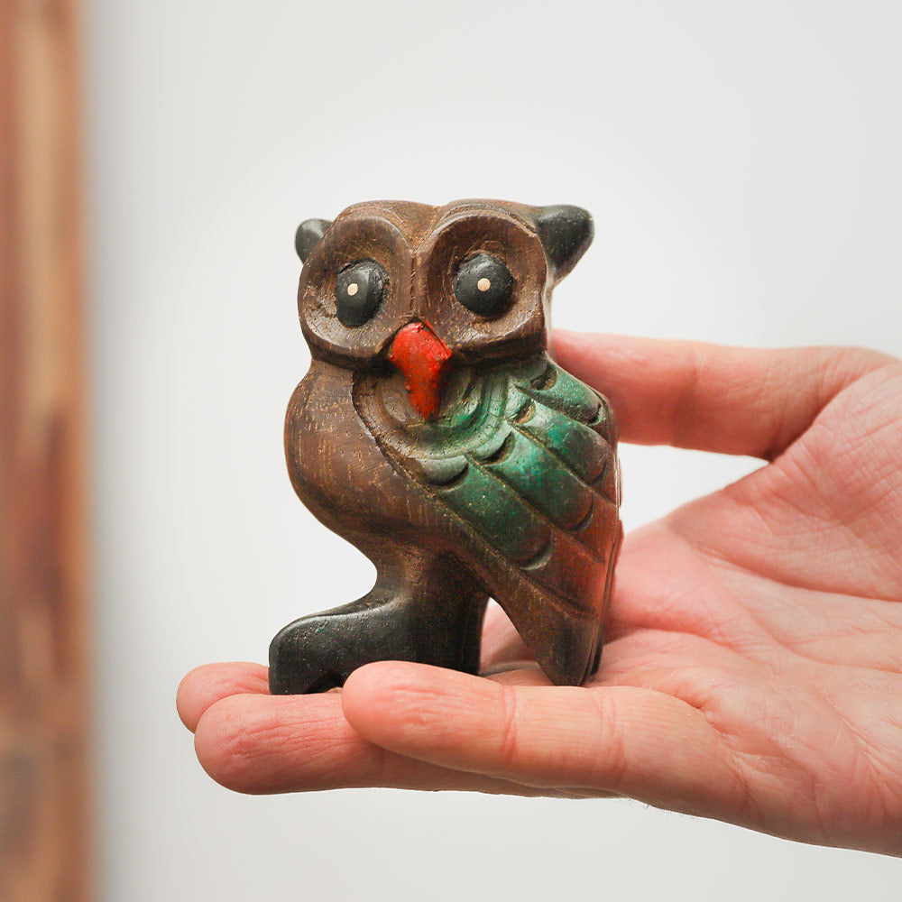 Handheld medium-sized hooting owl whistle, dark wood, intricately carved and painted, decorative ornament made in Northern Thailand.
