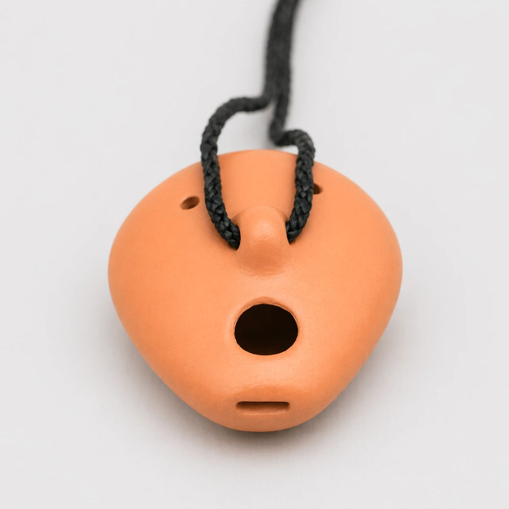 bottom of ocarina on white background