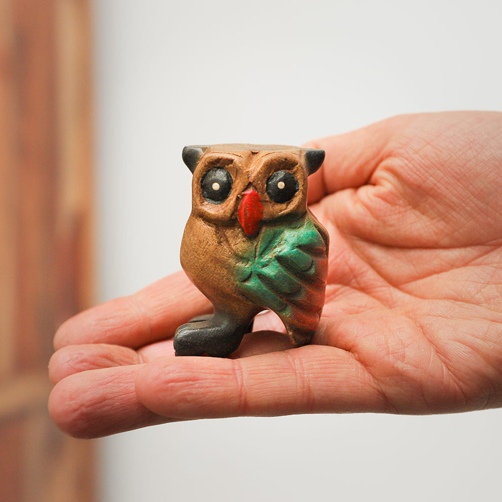 Handheld small hooting owl whistle, crafted from light wood, intricately carved and painted, decorative ornament from Northern Thailand.
