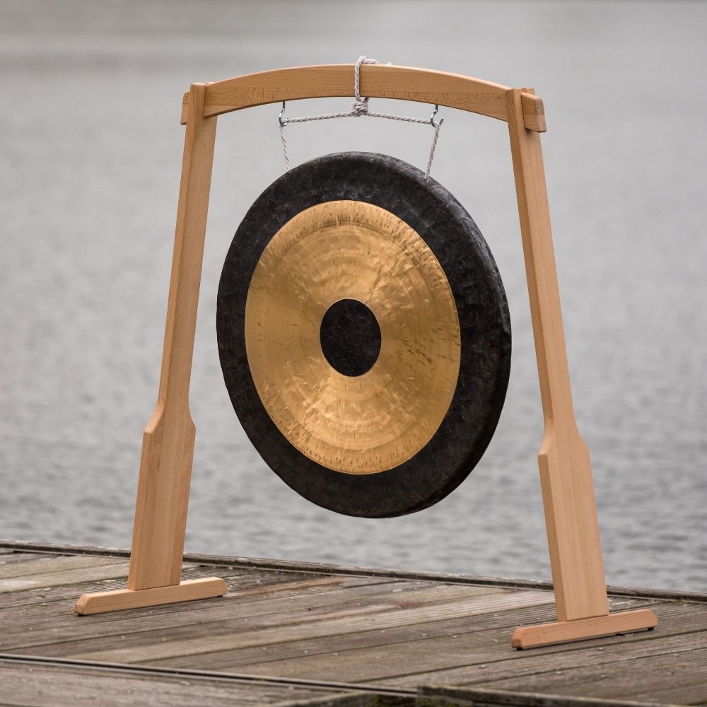 Gong on a wooden stand with a blurred natural background