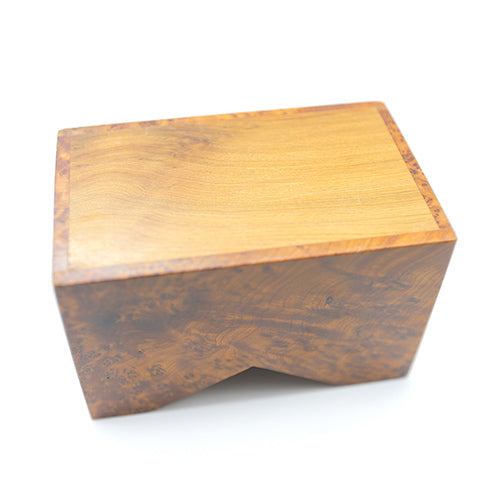 The bottom of a thuya wood business card holder