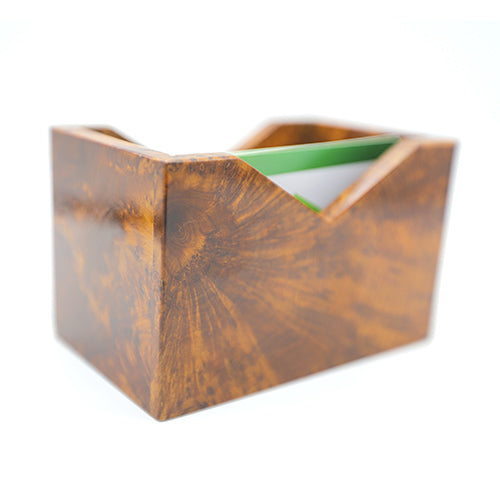 The side of a thuya wood business card holder with business cards