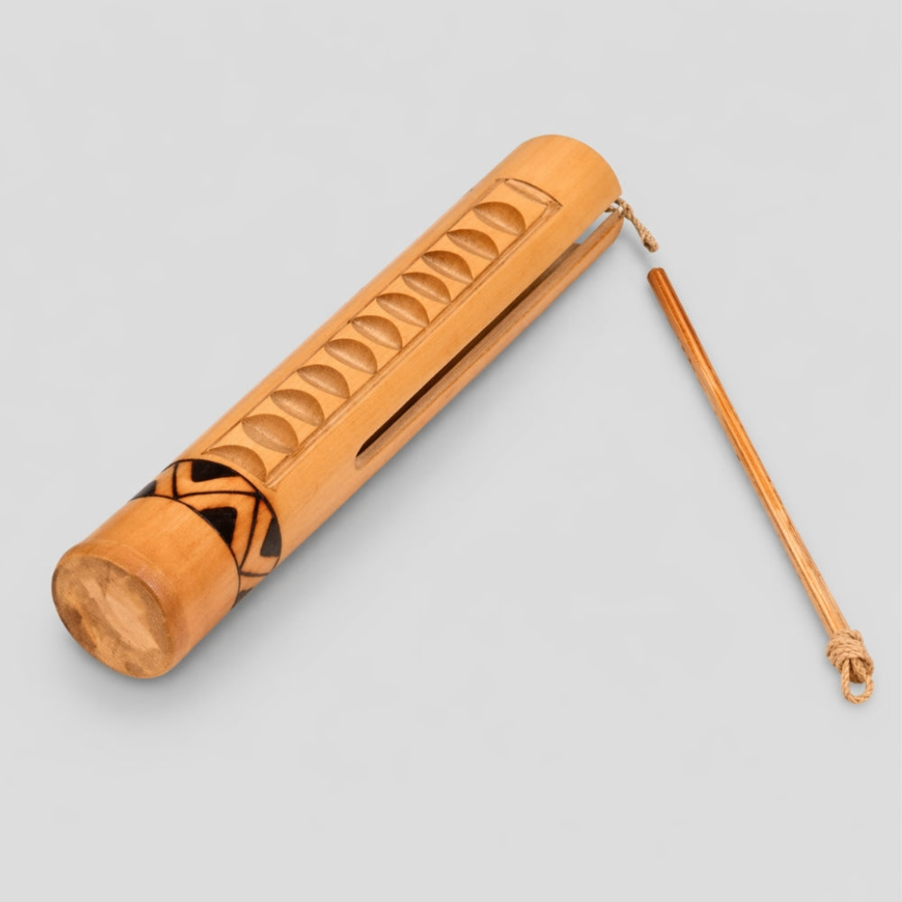 Bamboo Jati Guiro with rasp stick on a studio gray background
