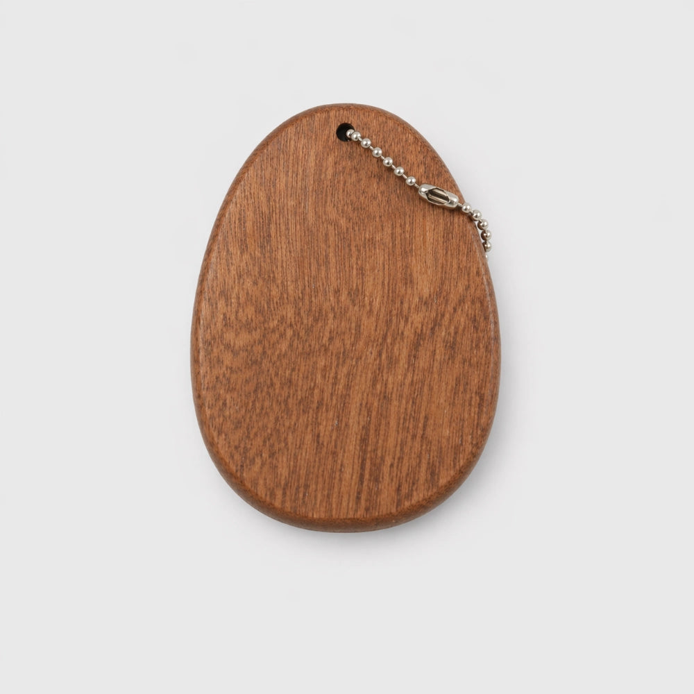 Back view of Chisai Pocket Kalimba with 8 notes on light grey studio background