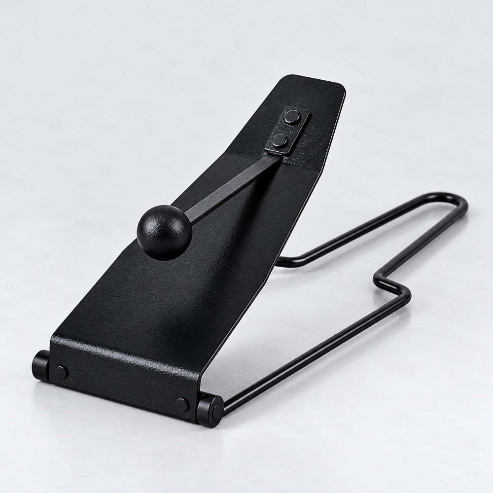 Front view of a black Flexatone metal pitch bending instrument on a light grey studio background