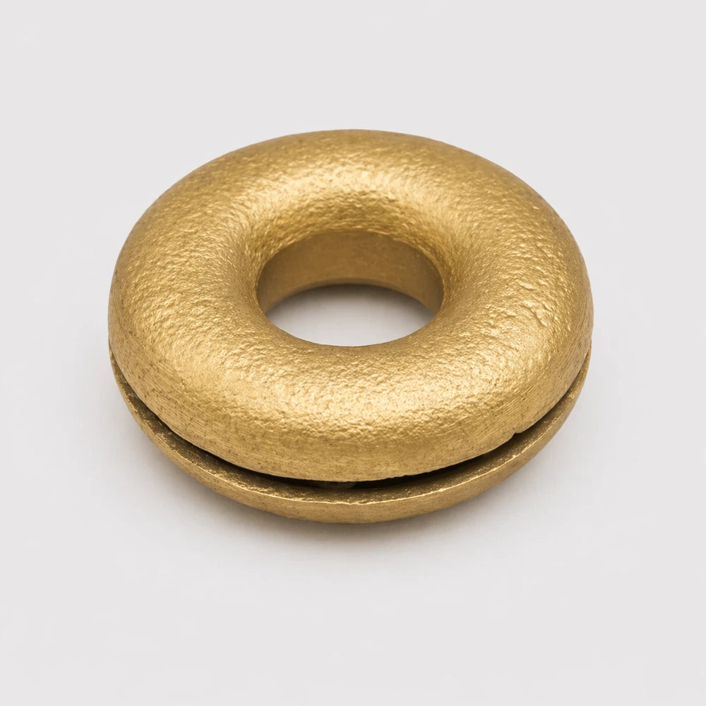 Bottom of the Brass Meo finger bell, showcasing the smooth surface.