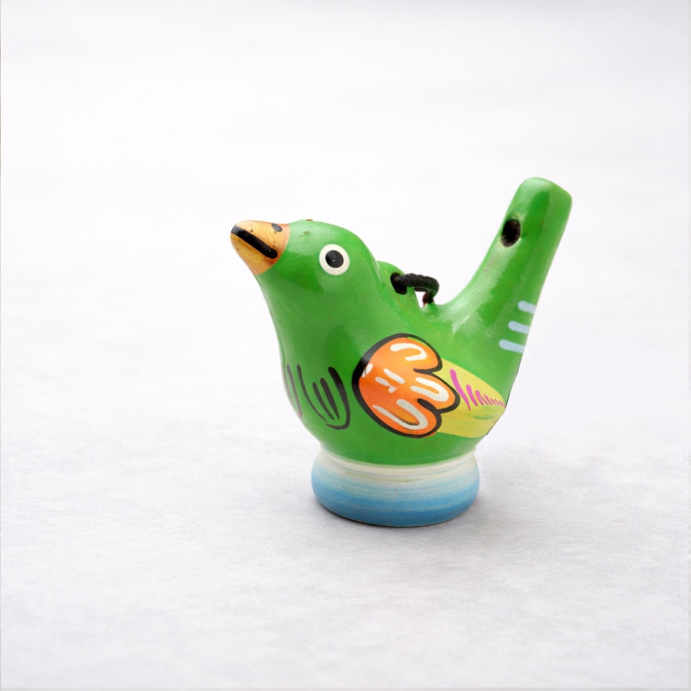 Green ceramic bird-shaped whistle on a white background
