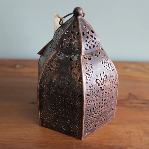 cast iron copper lantern on wooden table