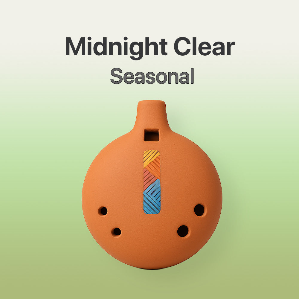 Ceramic ocarina with colorful design on a light green background, labeled 'Midnight Clear Seasonal'.