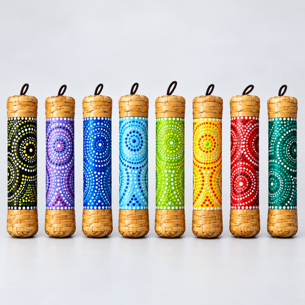 Seven 15cm rainstick colour designs lined up side by side on a light gray background. 