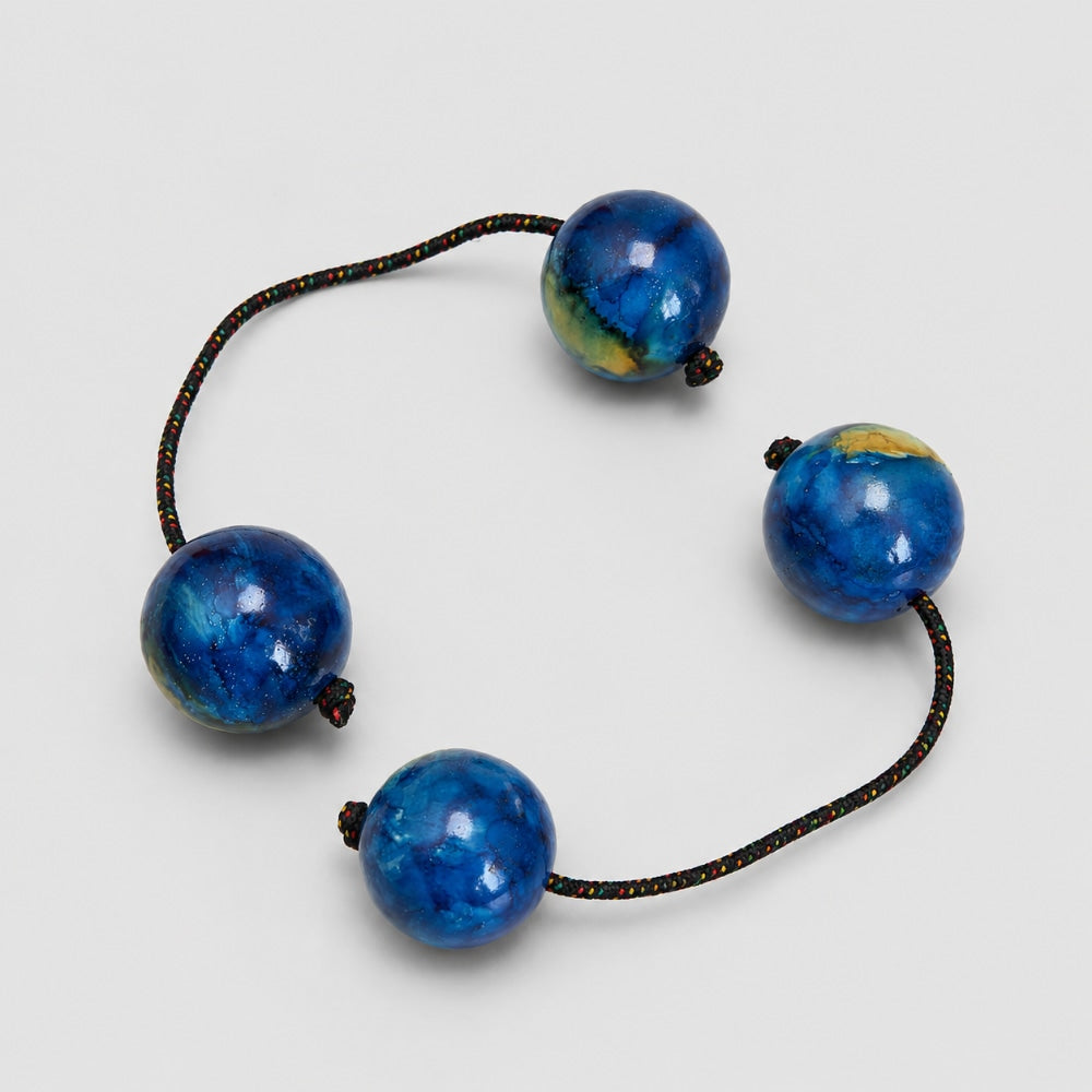 Pair of blue ocean kashaka shakers on a light grey studio background
