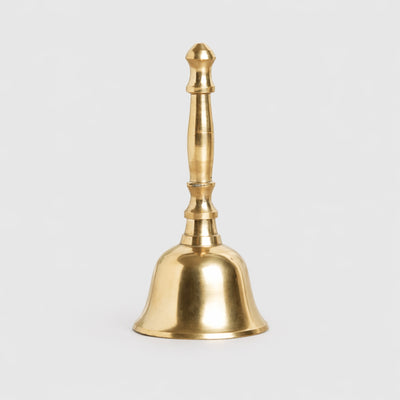 Gold bell on a light gray background