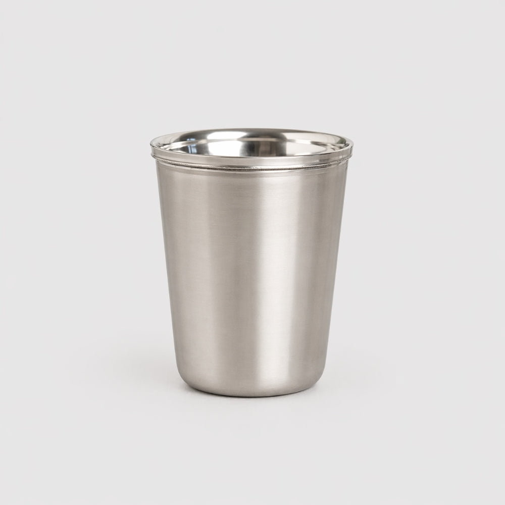 Stainless steel tumbler on a light gray background