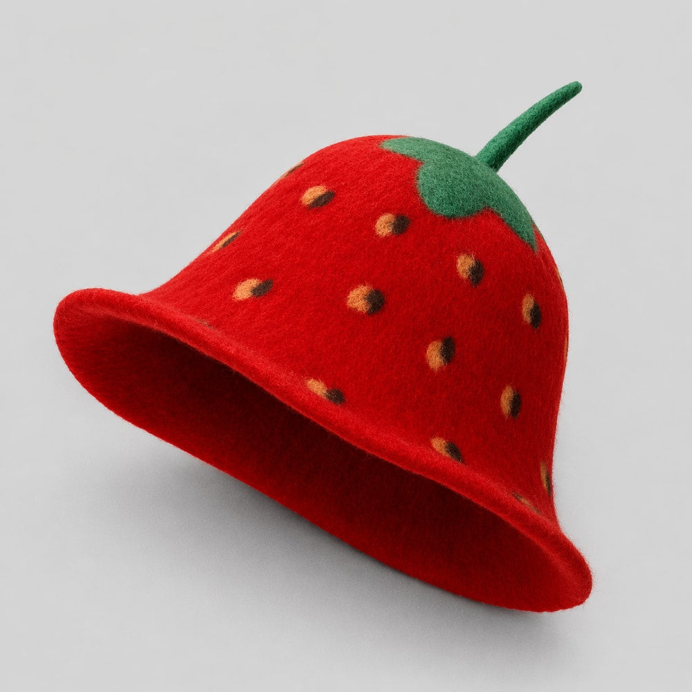 Red strawberry-shaped festival fruit hat with a green stem on a light gray studio background