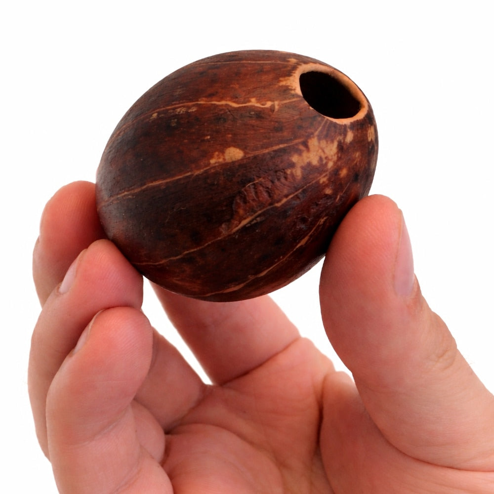 Hand holding a televi ball with a hole on a white background