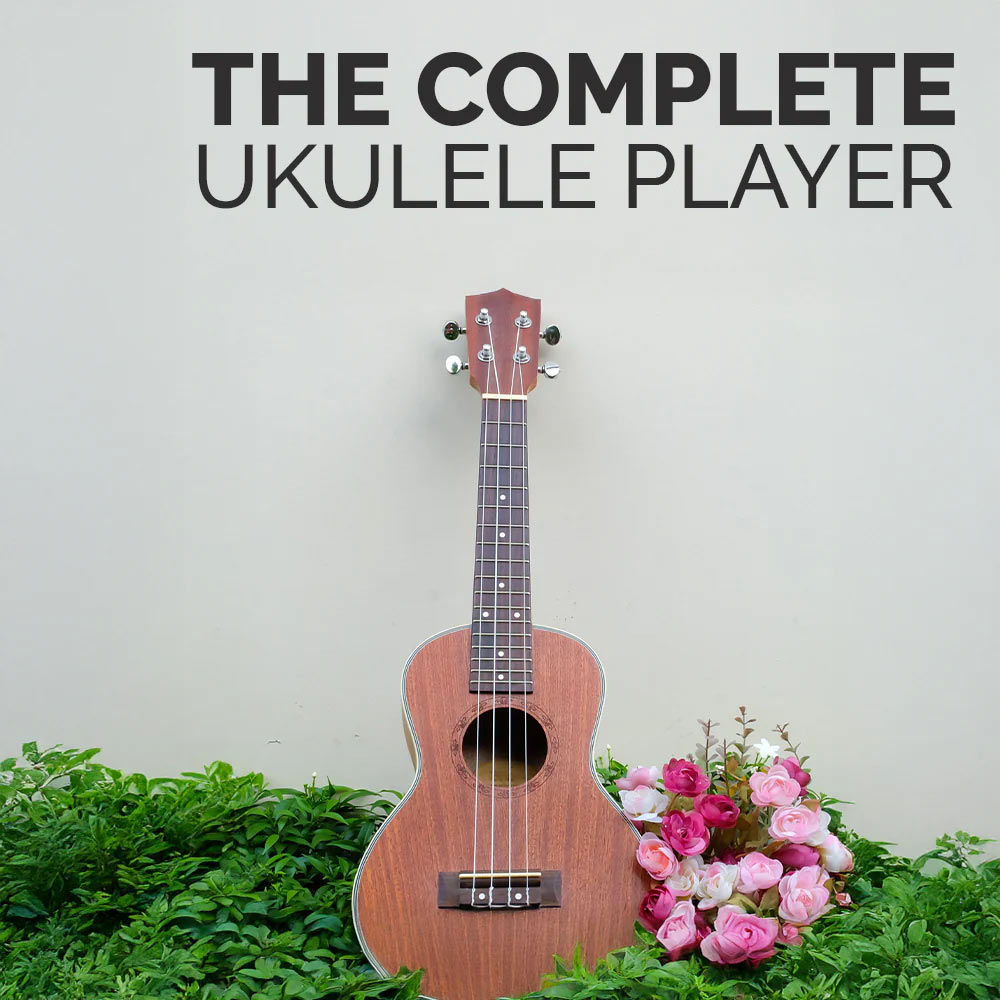 Book titled 'The Complete Ukulele Player' by Ryan Bomzer with a ukulele and flowers on a light gray background