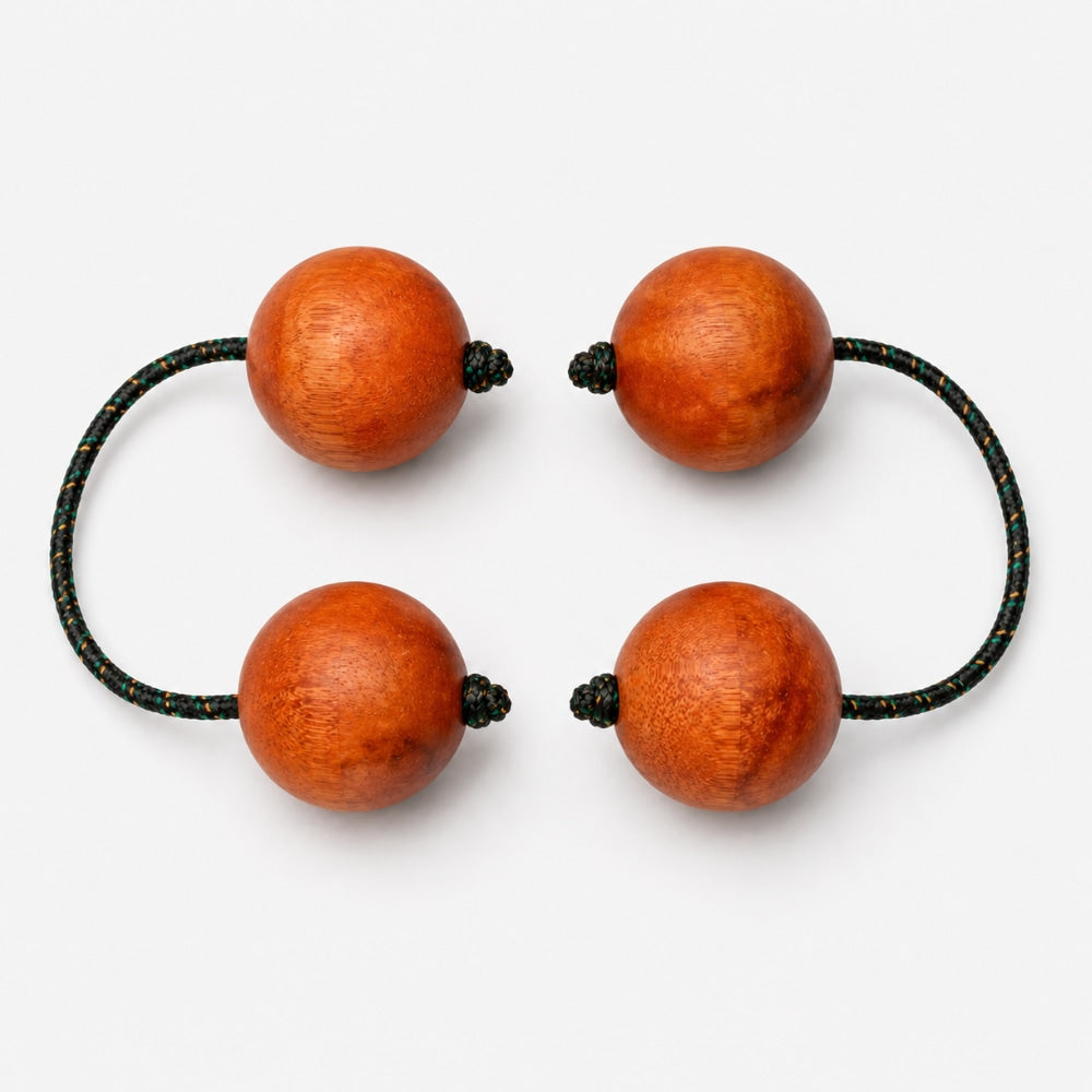 Pair wooden kashaka shaker on a light grey studio background
