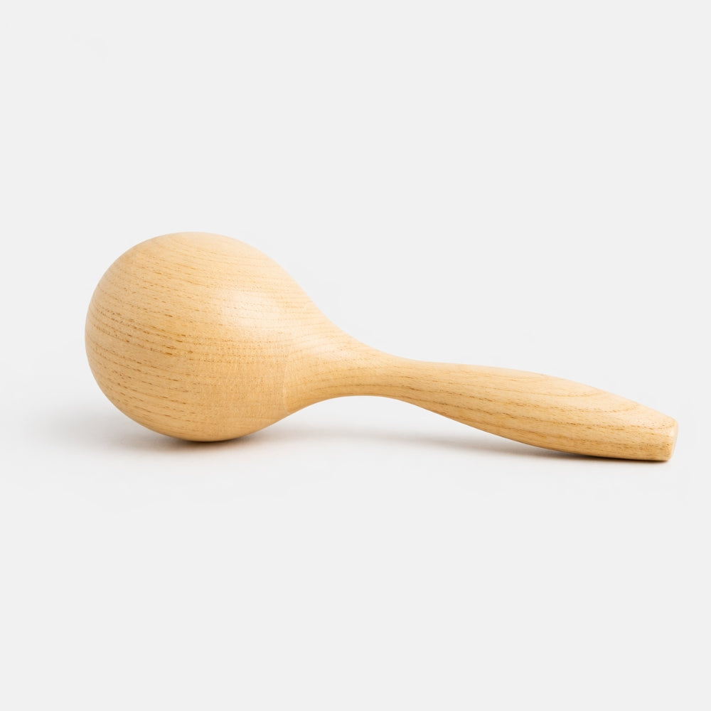 solid wood maraca shaker with grey background 