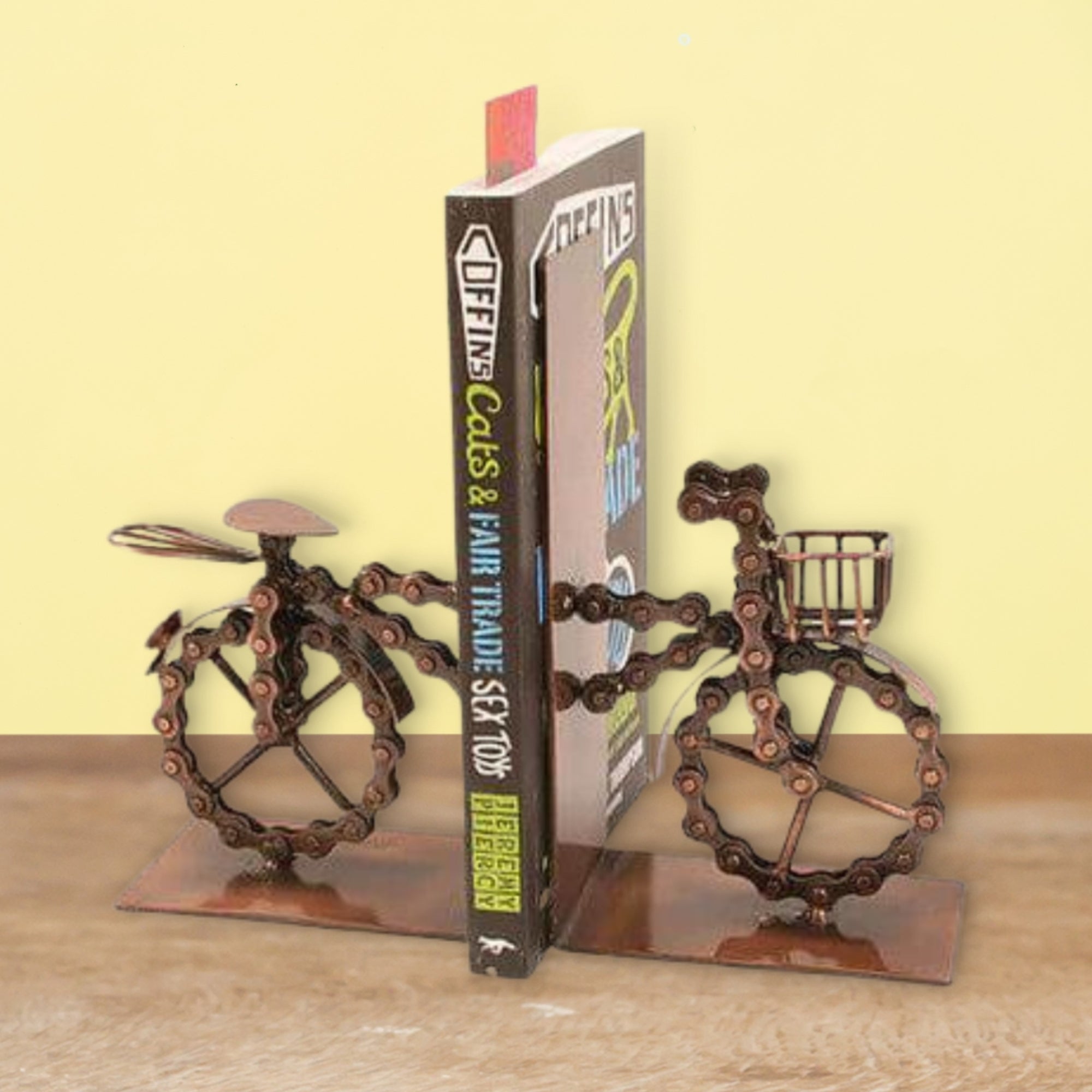 recycled bicycle bookends for storing books with yellow background