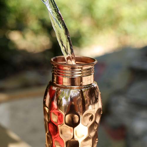 Water being poured on Copper Water Bottle (600 ml)