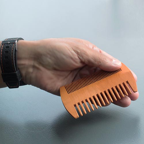 Solid pear wood comb in the hand