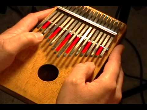 Playing with a Wooden Kalimba Thumb Piano