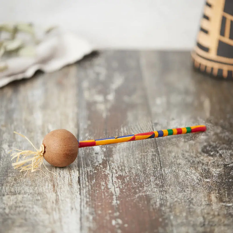 musical instrument shaker made from raffia and a single gourd nut