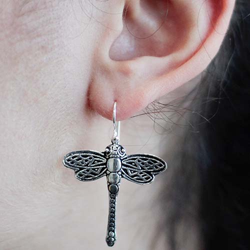 silver dragonfly earrings being worn