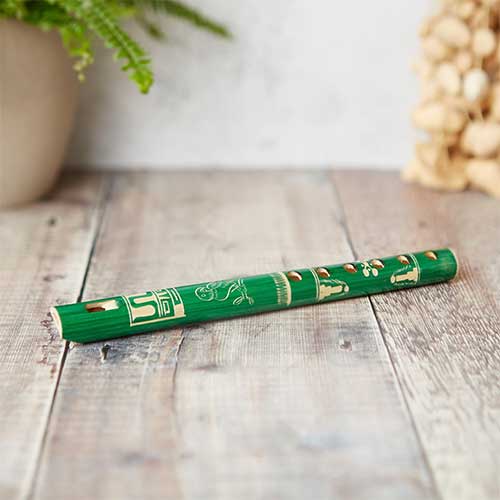 carved painted green wooden flute